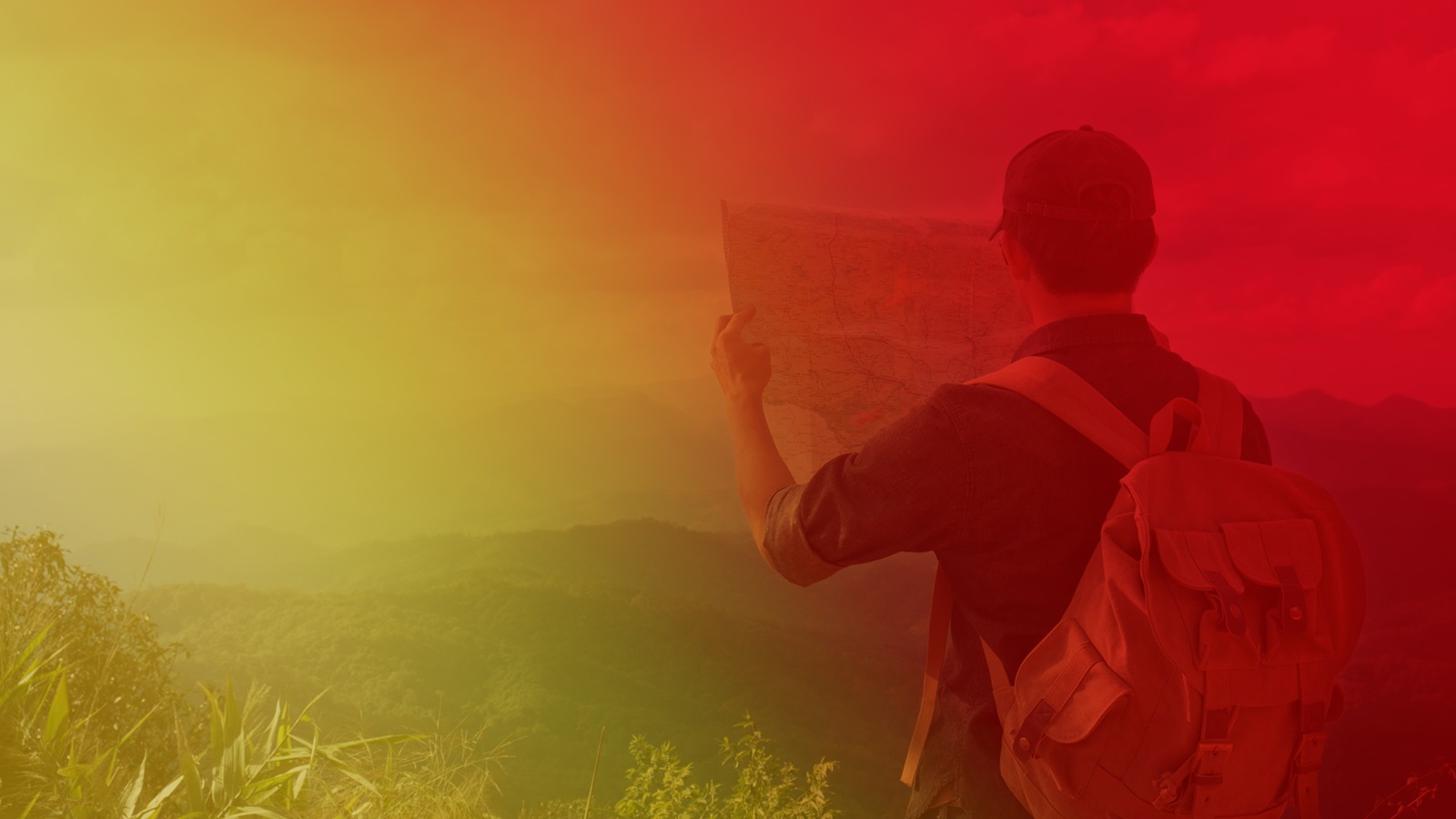 Student explorer looking at map peering out across landscape