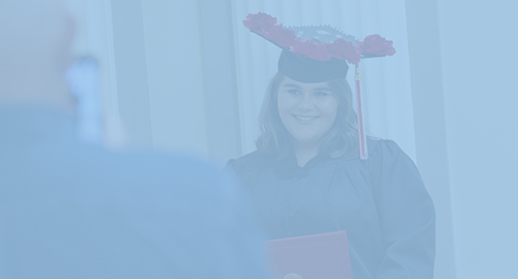 Graduate Expressions image, graduate wearing decorated cap smiling at camera, Virtual Graduation Experience 2021 